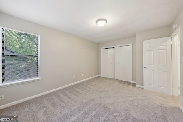 5362 Kelleys Mill Cir, Stone Mountain, GA 30088 - unfurnished bedroom featuring carpet, baseboards, and a closet