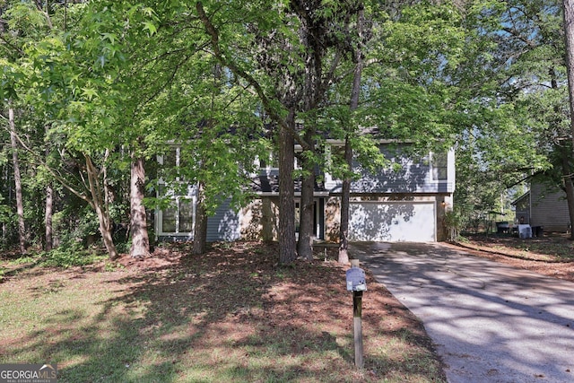 5362 Kelleys Mill Cir, Stone Mountain, GA 30088 - view of property hidden behind natural elements with a garage and driveway