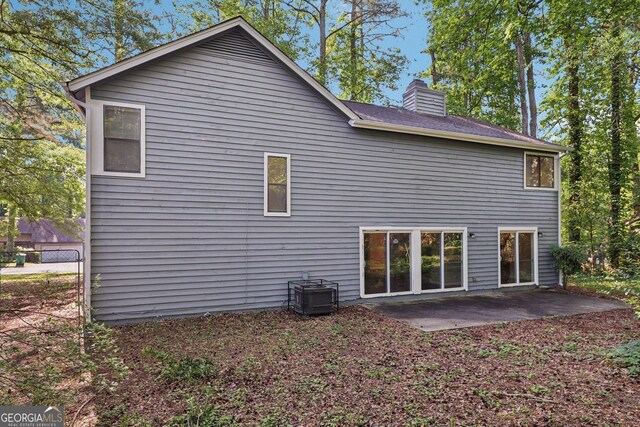 5362 Kelleys Mill Cir, Stone Mountain, GA 30088 - rear view of property featuring a patio and a chimney