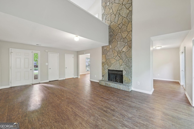 5362 Kelleys Mill Cir, Stone Mountain, GA 30088 - unfurnished living room featuring wood finished floors, a fireplace, and baseboards