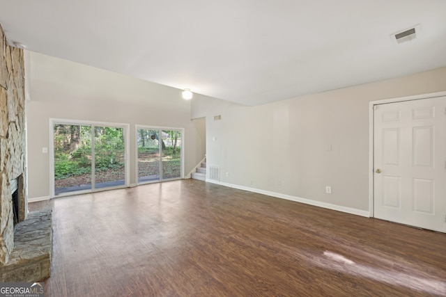 5362 Kelleys Mill Cir, Stone Mountain, GA 30088 - unfurnished living room with a fireplace, stairway, wood finished floors, and baseboards