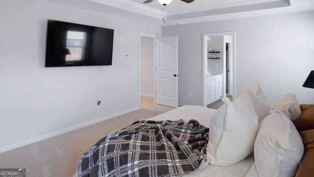20 Geranium Ln, Covington, GA 30016 - bedroom with a tray ceiling, carpet floors, connected bathroom, a ceiling fan, and baseboards