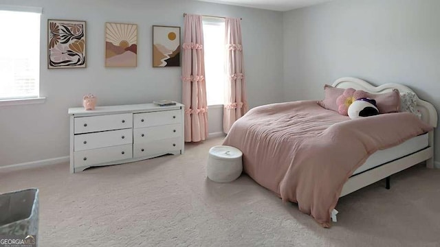20 Geranium Ln, Covington, GA 30016 - bedroom with light carpet, multiple windows, and baseboards
