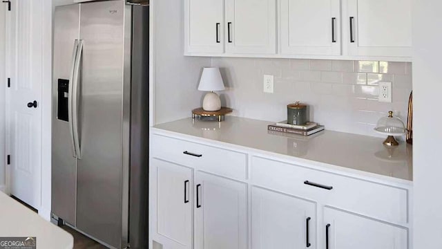 20 Geranium Ln, Covington, GA 30016 - kitchen featuring stainless steel fridge with ice dispenser, white cabinetry, and light countertops