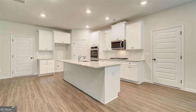120 Cooper Cv W Lot 60, Fayetteville, GA 30214 - kitchen with stainless steel appliances, white cabinetry, wood finished floors, and recessed lighting