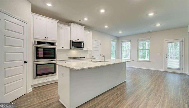 120 Cooper Cv W Lot 60, Fayetteville, GA 30214 - kitchen featuring stainless steel appliances, a center island with sink, wood finished floors, recessed lighting, and white cabinetry