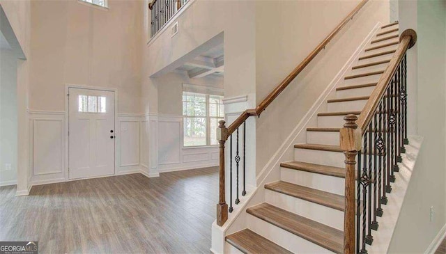 120 Cooper Cv W Lot 60, Fayetteville, GA 30214 - foyer entrance featuring a decorative wall, wood finished floors, stairs, wainscoting, and a high ceiling