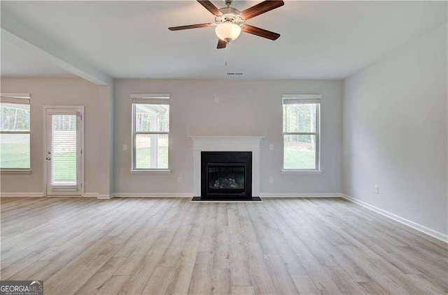 160 Cooper Cv W Lot 64, Fayetteville, GA 30215 - unfurnished living room with wood finished floors, plenty of natural light, a ceiling fan, and a fireplace with flush hearth