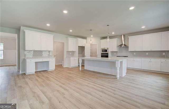 160 Cooper Cv W Lot 64, Fayetteville, GA 30215 - kitchen with wall chimney range hood, stainless steel microwave, black oven, backsplash, and white cabinetry