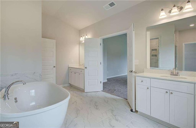 160 Cooper Cv W Lot 64, Fayetteville, GA 30215 - full bathroom featuring two vanities, a freestanding tub, marble finish flooring, vaulted ceiling, and a closet