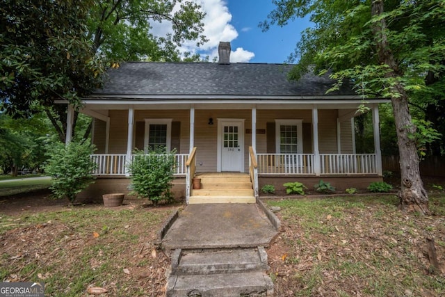 180 Cross St, Maysville, GA 30558 - view of front of house featuring roof with shingles, a porch, and a chimney