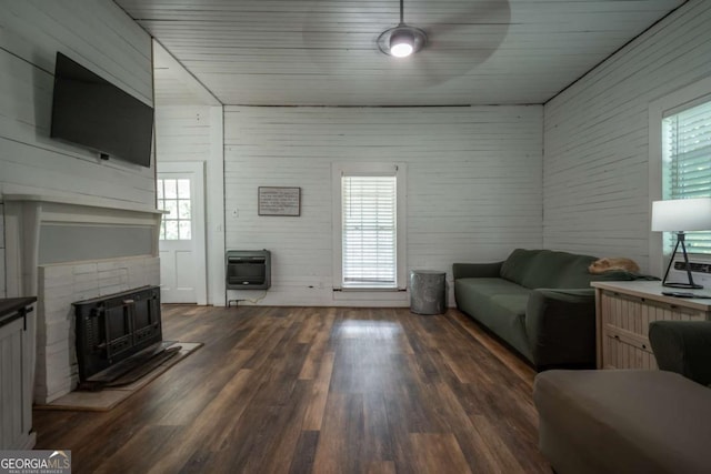 180 Cross St, Maysville, GA 30558 - living room featuring heating unit, healthy amount of natural light, a wood stove, and wood finished floors
