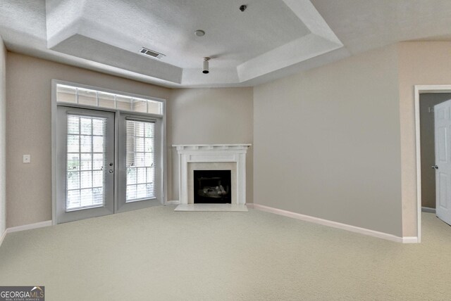 3500 Sweetwater Rd Unit 522, Duluth, GA 30096 - unfurnished living room with a tray ceiling, carpet floors, french doors, and baseboards