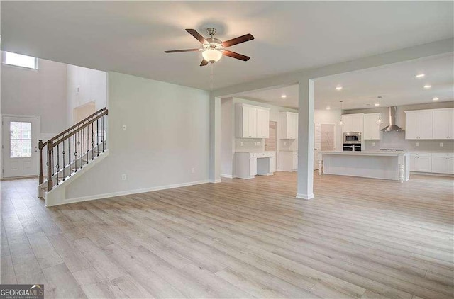 125 Cooper Cv W Lot 72, Fayetteville, GA 30215 - unfurnished living room featuring a ceiling fan, stairway, light wood-style floors, and recessed lighting