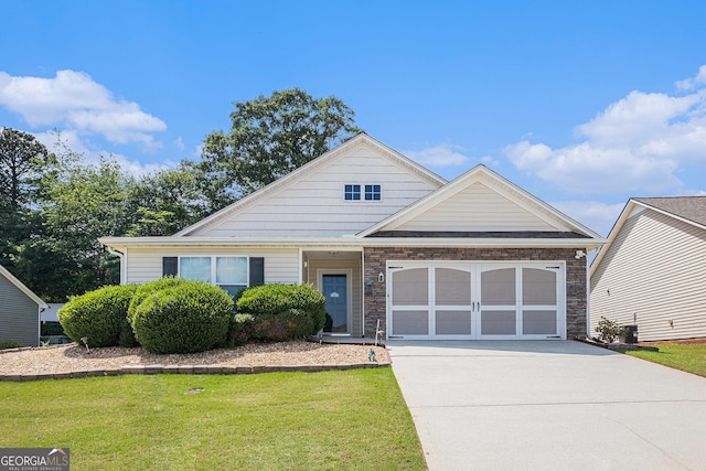 807 Ideal Pl, Winder, GA 30680 - view of front of property featuring concrete driveway, an attached garage, a front yard, and stone siding