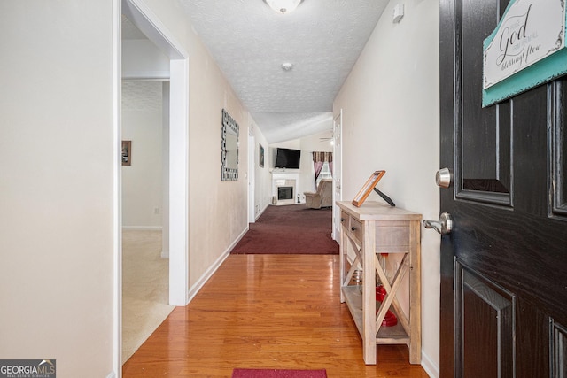 807 Ideal Pl, Winder, GA 30680 - corridor featuring a textured ceiling, light wood-style flooring, and baseboards