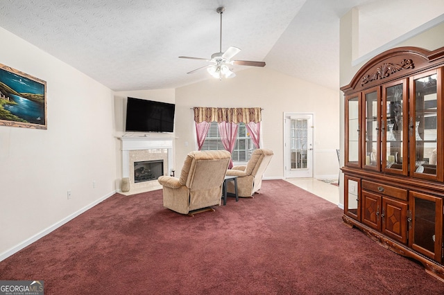 807 Ideal Pl, Winder, GA 30680 - living room featuring a high end fireplace, lofted ceiling, a ceiling fan, dark colored carpet, and baseboards