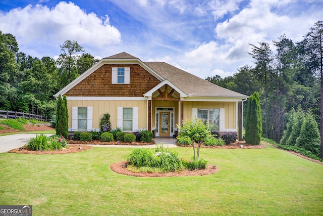 craftsman-style house featuring a front yard and board and batten siding