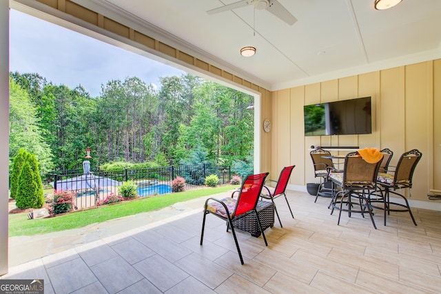 view of patio featuring fence, a ceiling fan, and outdoor dining space