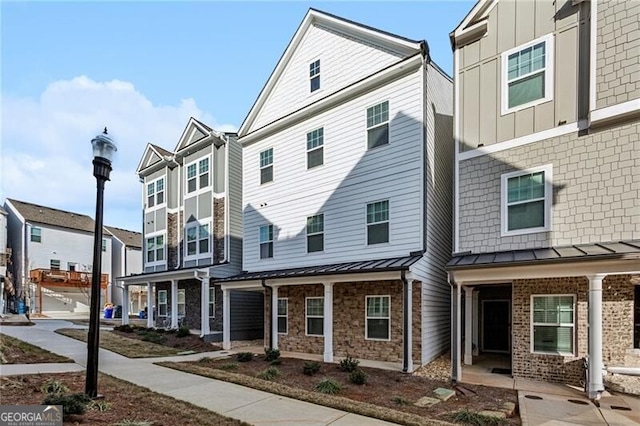 2111 Wesson Ct, Kennesaw, GA 30144 - view of property with a standing seam roof, board and batten siding, and metal roof