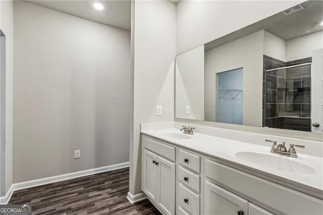 2111 Wesson Ct, Kennesaw, GA 30144 - full bathroom featuring a stall shower, double vanity, wood finished floors, baseboards, and recessed lighting