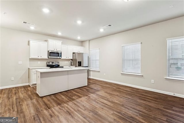 2111 Wesson Ct, Kennesaw, GA 30144 - kitchen featuring stainless steel appliances, an island with sink, dark wood-style flooring, baseboards, and recessed lighting