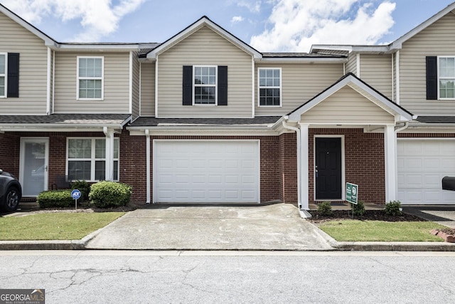 132 Tara Commons Dr, Loganville, GA 30052 - townhome / multi-family property featuring driveway, brick siding, and a garage
