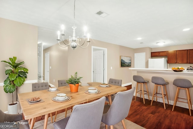 132 Tara Commons Dr, Loganville, GA 30052 - dining area featuring a chandelier, dark wood-style floors, baseboards, and recessed lighting