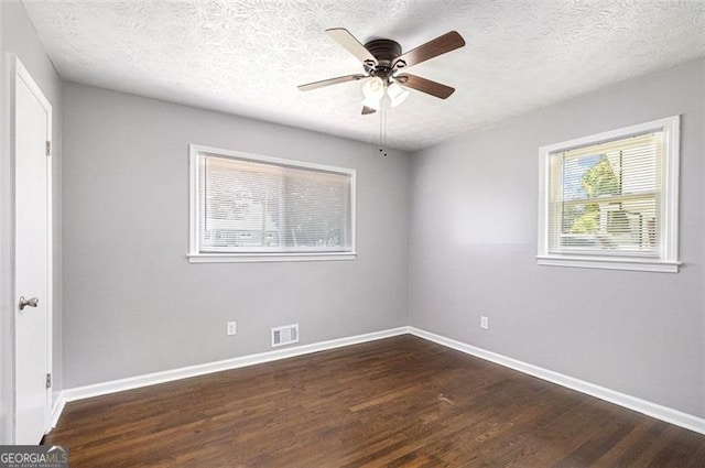 spare room with wood finished floors, baseboards, a textured ceiling, and ceiling fan