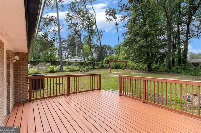 wooden terrace featuring a lawn and view of wooded area
