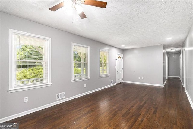 unfurnished living room featuring wood finished floors, a textured ceiling, ceiling fan, and baseboards