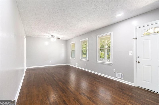 entrance foyer with wood finished floors, ceiling fan, baseboards, and a textured ceiling