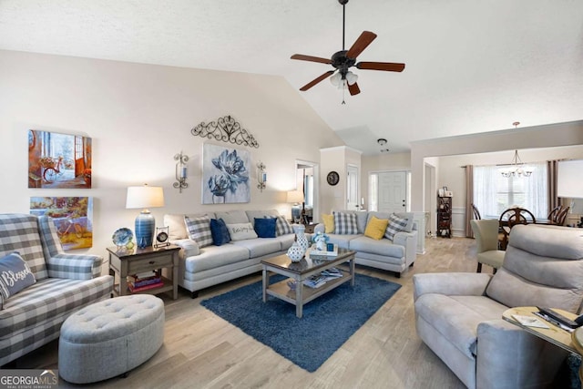 102 Autumn Brooke Trl, Dallas, GA 30157 - living room with a chandelier, ceiling fan, light wood-style floors, and high vaulted ceiling