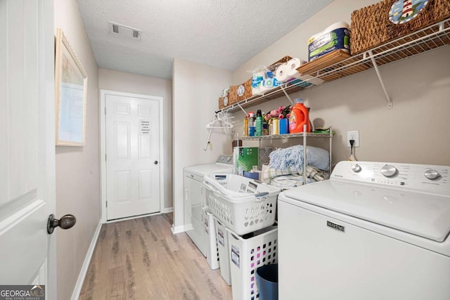 102 Autumn Brooke Trl, Dallas, GA 30157 - washroom featuring light wood-style flooring, washing machine and dryer, and a textured ceiling