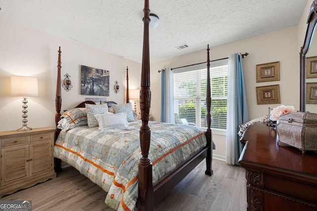 102 Autumn Brooke Trl, Dallas, GA 30157 - bedroom with light wood finished floors and a textured ceiling
