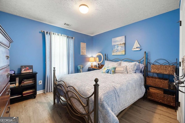 102 Autumn Brooke Trl, Dallas, GA 30157 - bedroom with a textured ceiling and wood finished floors
