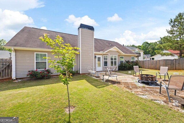 102 Autumn Brooke Trl, Dallas, GA 30157 - back of property with an outdoor fire pit, a patio, and a chimney