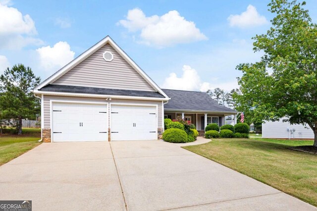 102 Autumn Brooke Trl, Dallas, GA 30157 - view of front of home featuring concrete driveway, a front lawn, stone siding, an attached garage, and a porch