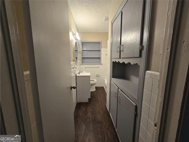 767 Vinson Pl SW, Atlanta, GA 30315 - bathroom with a textured ceiling, wood finished floors, vanity, and toilet