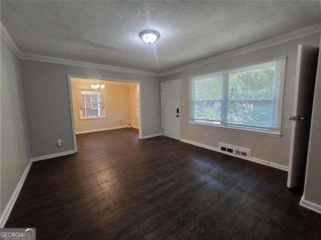 767 Vinson Pl SW, Atlanta, GA 30315 - spare room featuring a chandelier, dark wood-style floors, a textured ceiling, ornamental molding, and baseboards