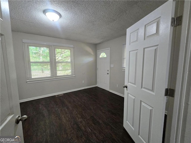 767 Vinson Pl SW, Atlanta, GA 30315 - foyer entrance with a textured ceiling, dark wood-style floors, and baseboards