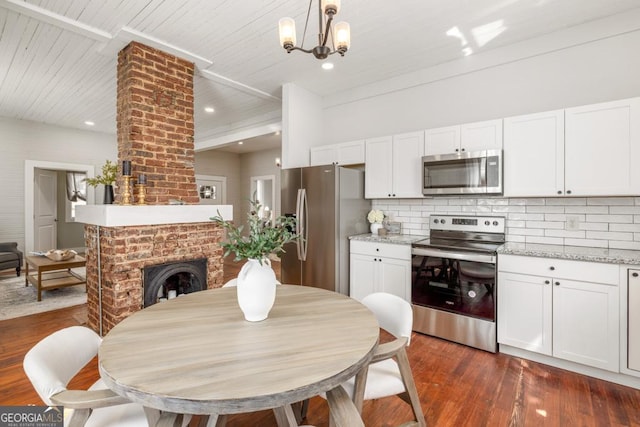 11 Pine St, Covington, GA 30014 - dining area with dark wood finished floors, a chandelier, a fireplace, recessed lighting, and wooden ceiling