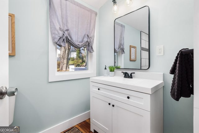 11 Pine St, Covington, GA 30014 - bathroom featuring vanity, baseboards, and wood finished floors