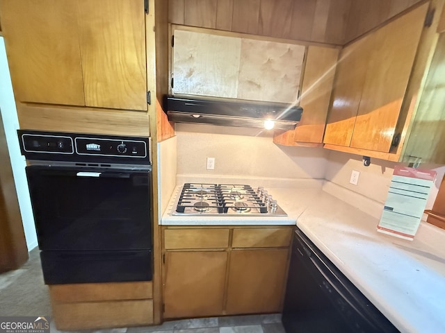 kitchen featuring black appliances, light countertops, and under cabinet range hood
