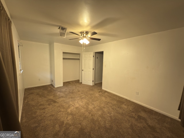 unfurnished bedroom with dark carpet, a closet, baseboards, and ceiling fan