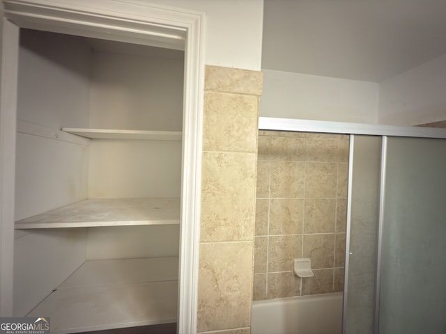 bathroom with a shower with door and a tub to relax in
