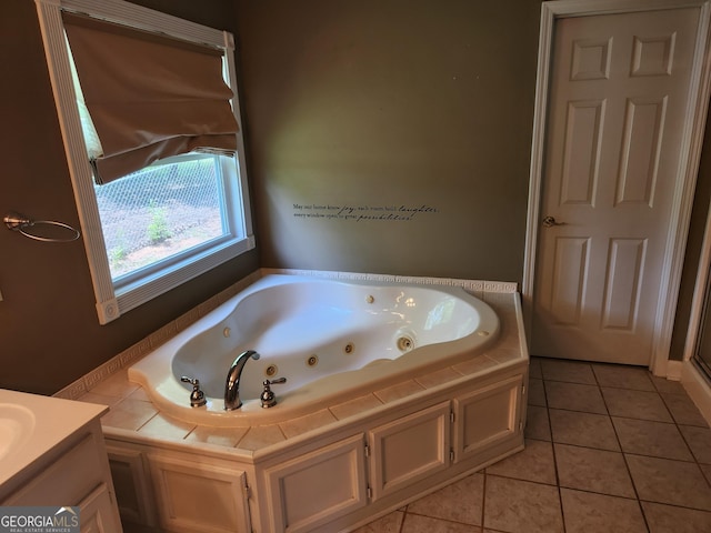 bathroom featuring tile patterned floors, a jetted tub, and vanity