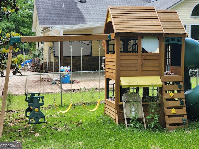 view of jungle gym featuring fence
