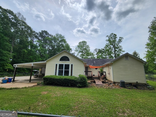 rear view of house featuring a carport, a deck, and concrete driveway