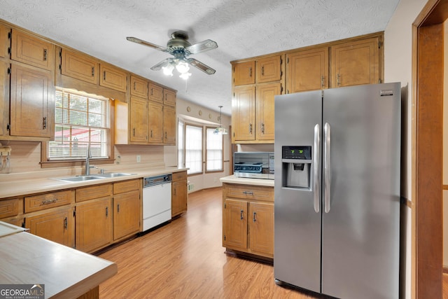 95 Stephens Dr, Covington, GA 30016 - kitchen with stainless steel fridge, dishwasher, a sink, ceiling fan, and light wood finished floors